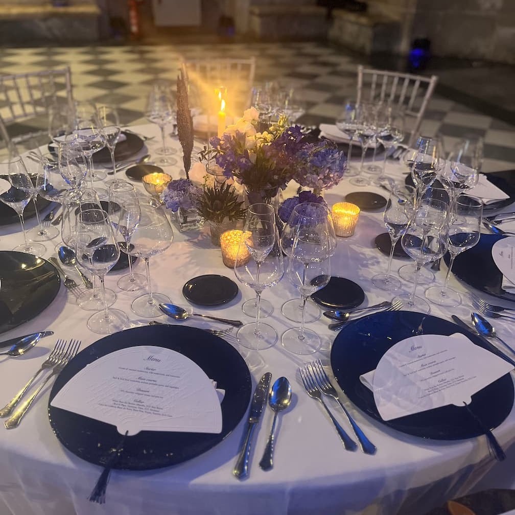 Candlelit gala tablescape with navy chargers and florals